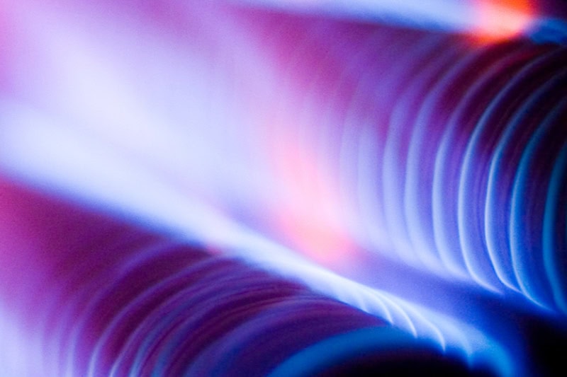 What Is That Burning Smell Coming From My Furnace?  Close up photo of blue and red coils from inside a furnace.